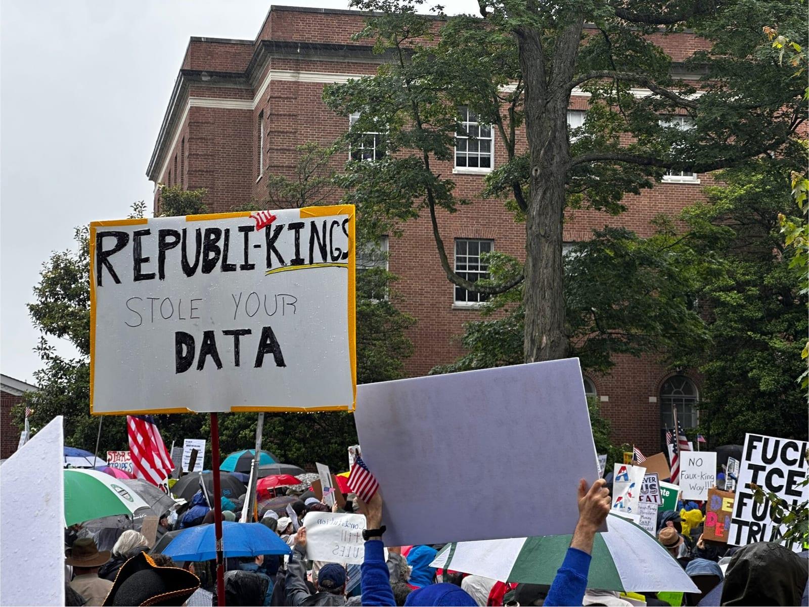 Protesters with signs at a No Kings rally in Morristown, New Jersey, June 14, 2025